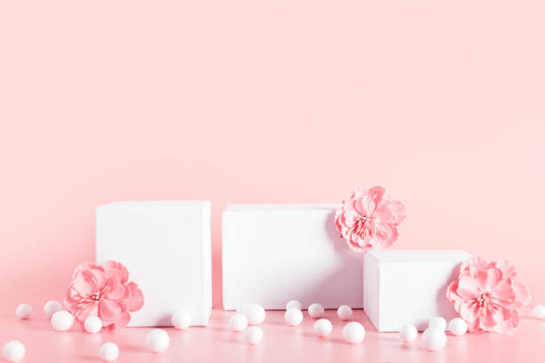 istock White empty stands decorated  flowers on beige background. 1320624386