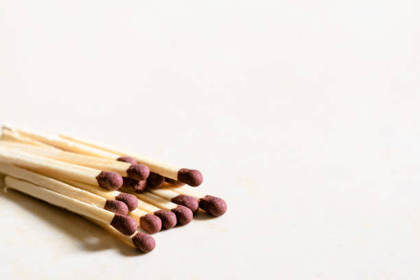 istock Matchsticks stacked and spread on white colored background to left side. Used selective focus. 1320625107