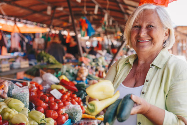 istock Smiling lady buying fresh peppers. 1320625598
