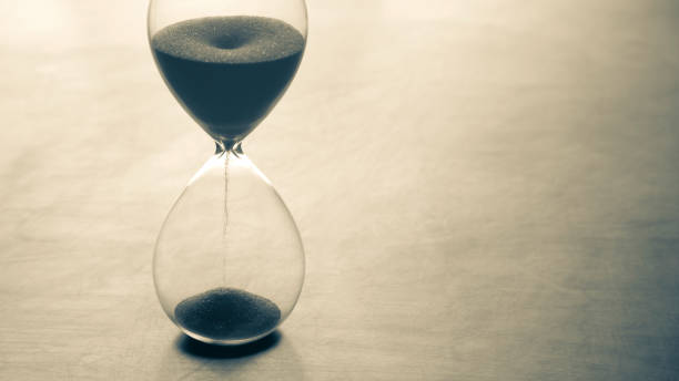 istock Hourglass on a light background. Time is money. Business solutions in time. 1320626191