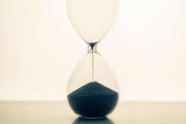 istock Hourglass on a light background. Time is money. Business solutions in time. 1320626726
