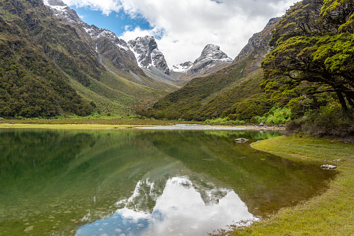 Tranquil mountain lake Mackenzie at the famous Routeburn Track, Fiordland National Park, South Island of New Zealand