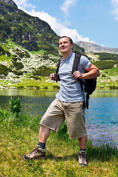 istock Mountaineer with backpack hiking into the mountains 132063117