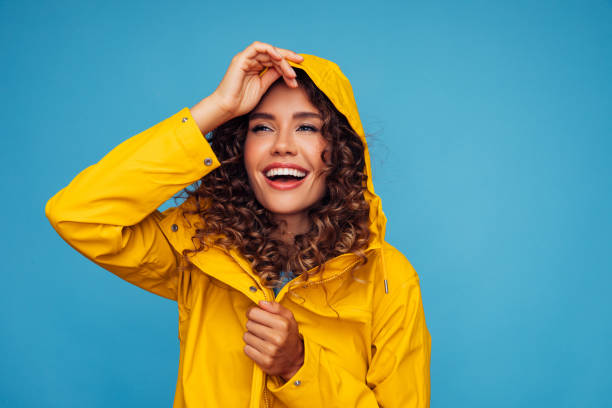 istock Smiling beautiful woman in raincoat 1320631819