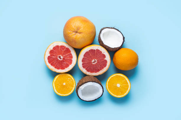 istock exotic fruits on a blue background. Coconut, orange, grapefruit. Top view, flat lay 1320632010