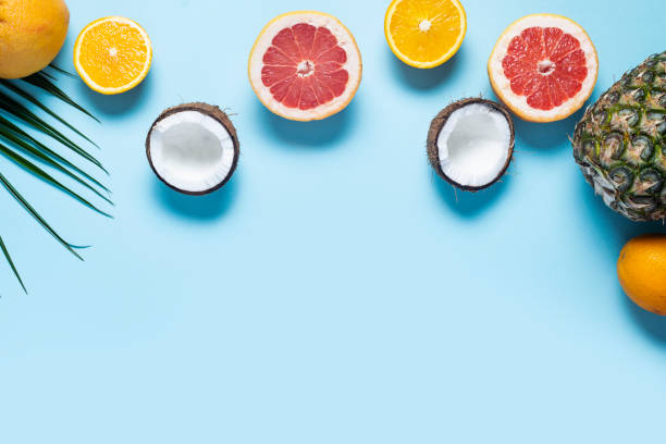 istock exotic fruits on blue. Pineapple, coconut, orange, grapefruit. Top view, flat lay 1320632573