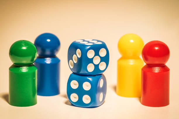 istock Four colored dices and two dices on the desk 1320635913