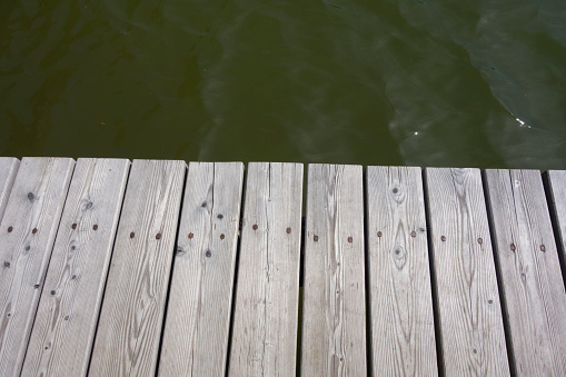 Water surrounding a traditional wooden pier