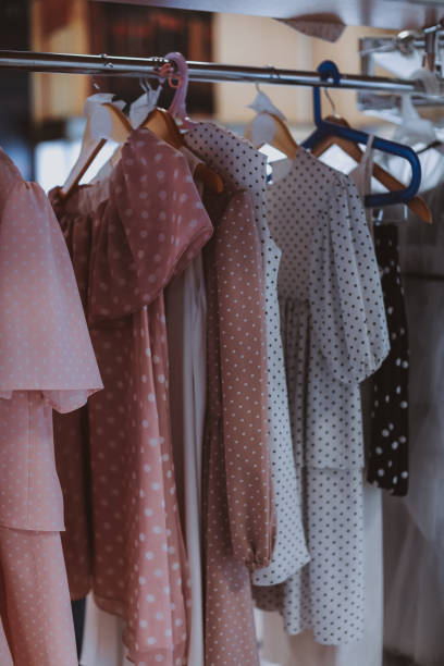 Pink and white polka dot girly dresses on a hanger