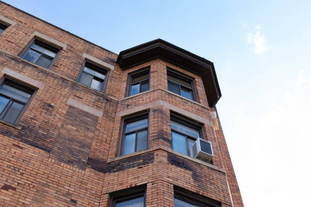 istock Very old brick apartment building with new replacement windows 1320638633