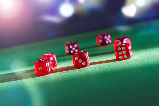 istock Dice playing on green felt on a dark background 1320638968