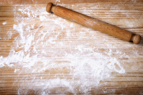 istock Pastry board with flour and rolling pin. Background, copy space. 1320639642