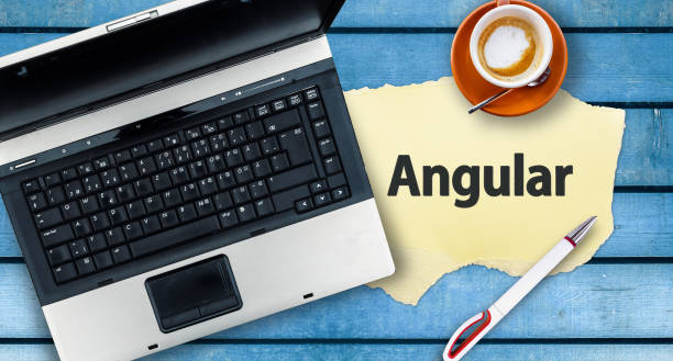 Word Angular on paper and laptop Angular web framework javascript stock pictures, royalty-free photos & images