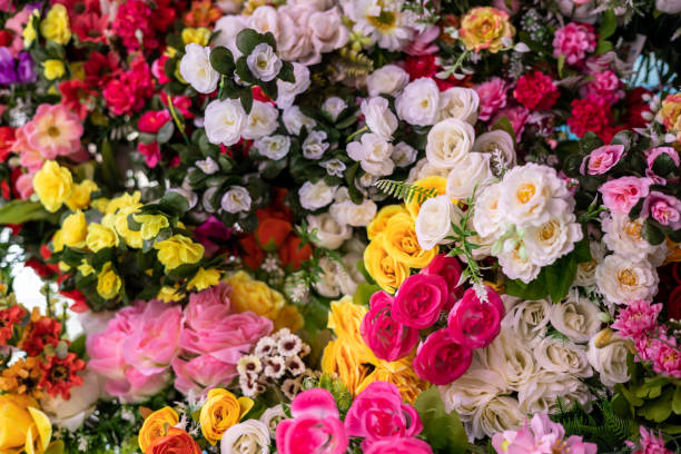 istock Many colorful artificial fake flowers background blooming beautiful. 1320641327