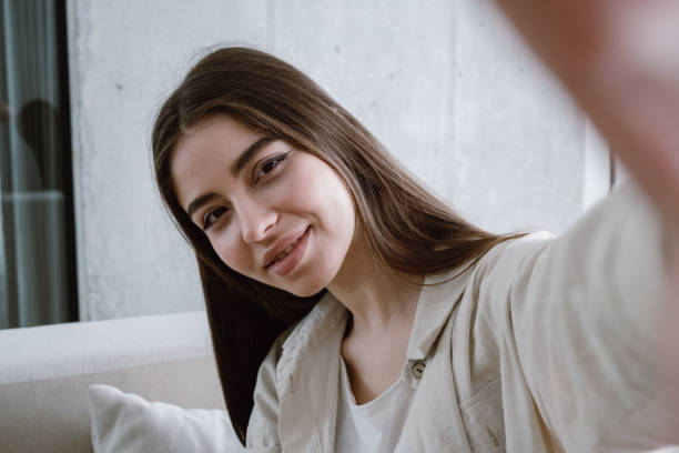 istock Young woman taking self portrait on camera 1320641954