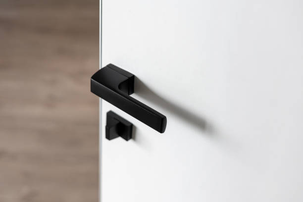 istock Black matte doorhandle on white interior door 1320642047