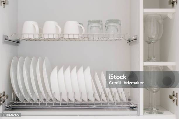 White Kitchen Storage Cabinet With Clean Dishes Stock Photo - Download Image Now - Cabinet, Organization, Kitchen