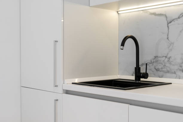 istock White kitchen counter with stylish black sink 1320642151