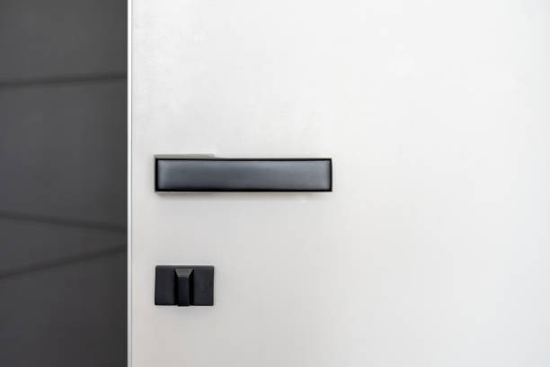 istock Black matt door handle on white wooden door 1320642155