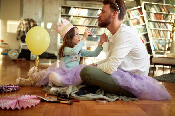 istock A young father waiting for his daughter to put a lipstick on his lips while they preparing for a ballet training at home. Family, together, home 1320643196