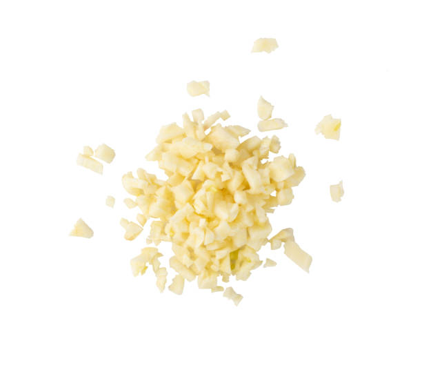Fresh Garlic Parts Isolated on White Background Fresh chopped minced garlic isolated on white background. Heap of crushed garlic cloves top view garlic stock pictures, royalty-free photos & images