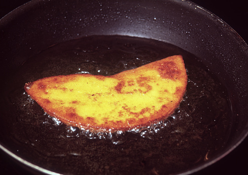Cooking empanada with oil in a pan