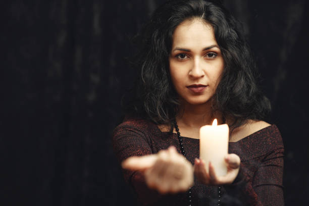 istock Portrait of fortune-teller in a dark room 1320645761