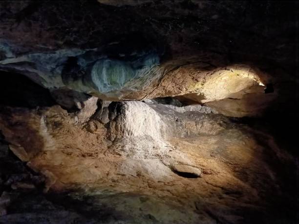 istock Underground mountain cave with river and stalactites and stalagmites 1320647765