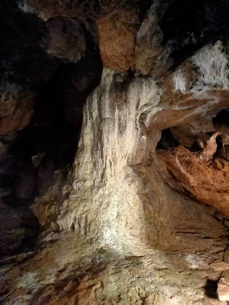 istock Underground mountain cave with river and stalactites and stalagmites 1320647775