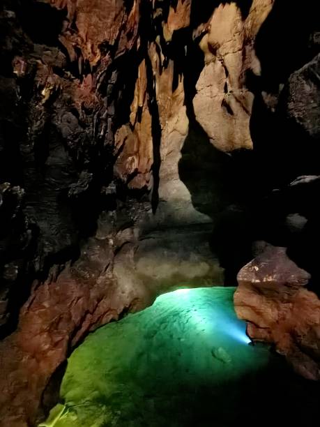 istock Underground mountain cave with river and stalactites and stalagmites 1320649005