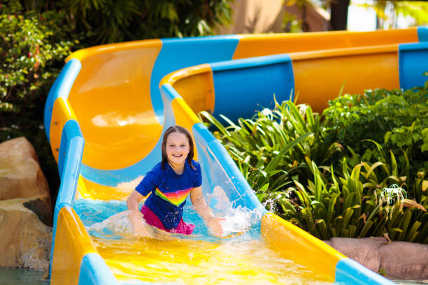 istock Kids on water slide in aqua park. Summer vacation 1320649019