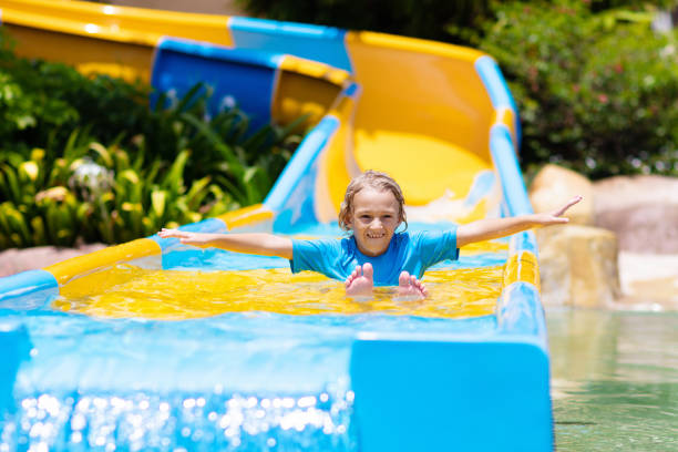 istock Kids on water slide in aqua park. Summer vacation 1320649069