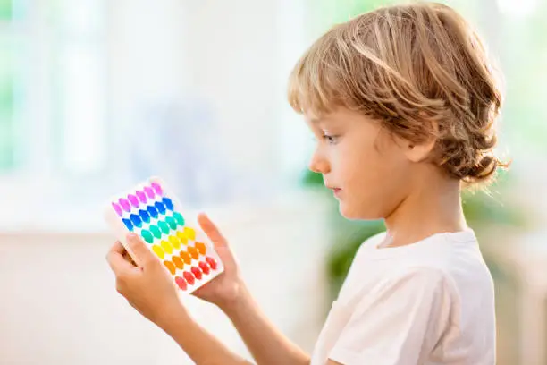 Photo of Kids with pop it sensory toy. Stress relief.