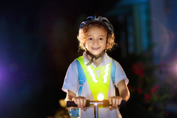 safety on dark street. kids reflective vest. - child bicycle cycling danger imagens e fotografias de stock