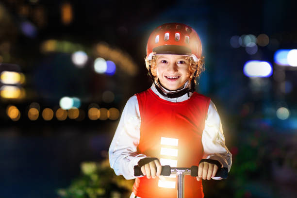safety on dark street. kids reflective vest. - child bicycle cycling danger imagens e fotografias de stock