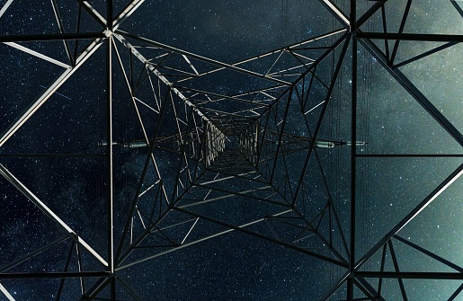 Looking up to the stars from under a hydro power transmission tower