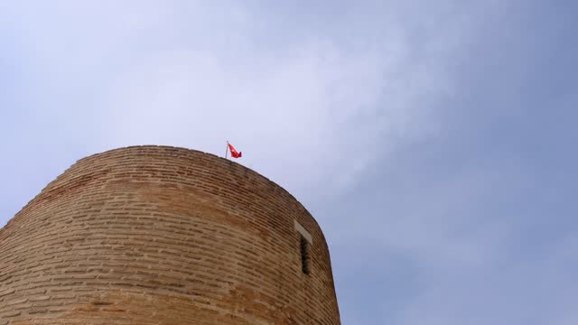 Turkish flag waving on top of the castle and fort made of red bricks