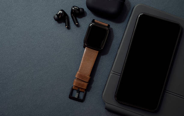 istock Mockup black screen smartphone and smartwatch on black leather background. 1320657506