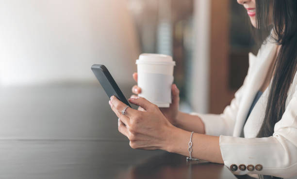 istock Cropped shot of woman hand. using smartphone while sitting in cafe. 1320658241