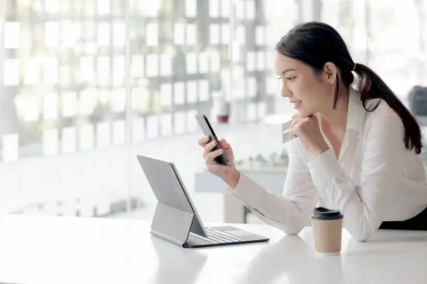 Photo of Beautiful businesswoman using smartphone shopping online.