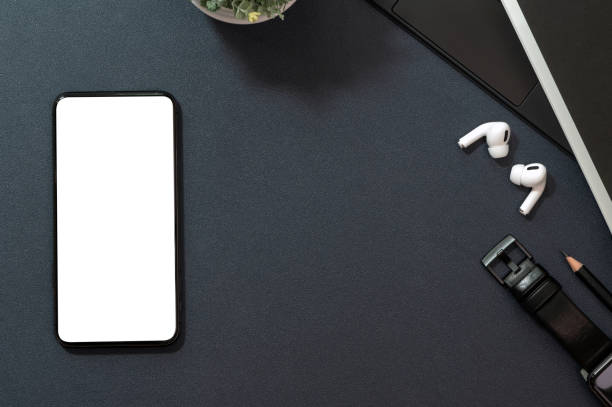istock Mockup blank screen smartphone and gadget on black leather background. 1320658709