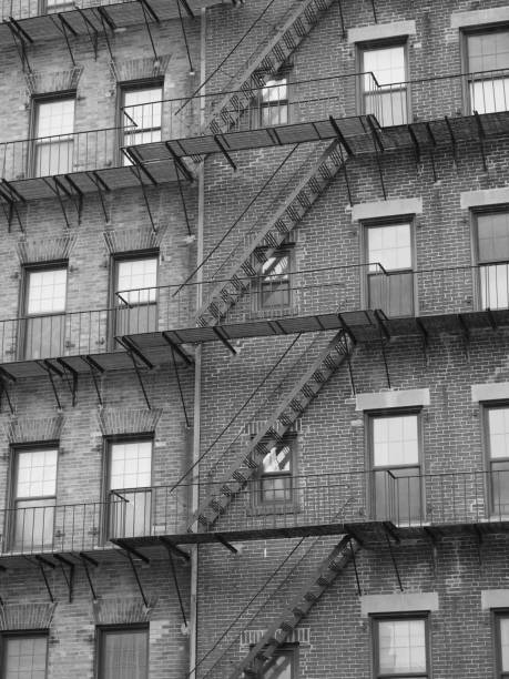 istock A large brick apartment building with lots of fire escapes. 1320659408
