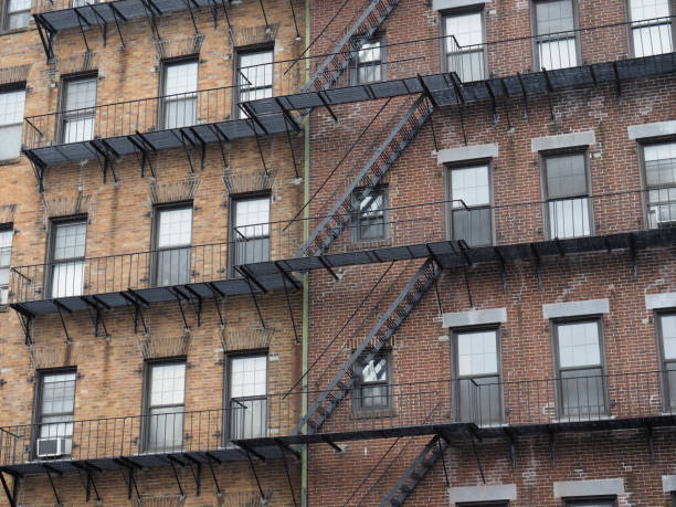 istock A large brick apartment building with lots of fire escapes. 1320659429