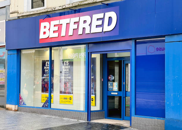 Exterior of a branch of the Betfred chain of betting shops Merthyr Tydfil, Wales - May 2021: Exterior view of the front of a branch of Betfred chain of betting shops. merthyr tydfil stock pictures, royalty-free photos & images