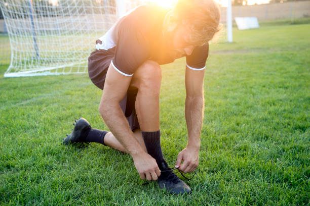 istock Soccer player tying his shoelaces 1320660372