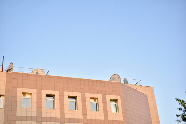 istock TV tower antenna with tree and TV center building 1320663810