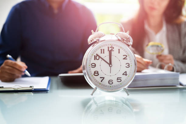 istock Accountant With Alarm Clock And Calculator 1320664423