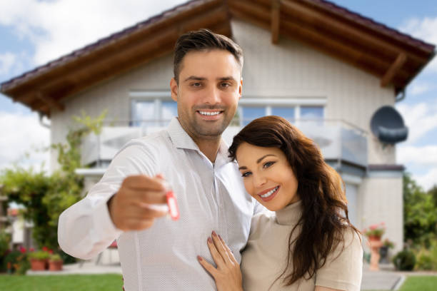 istock Happy Couple Holding Home Keys 1320666686