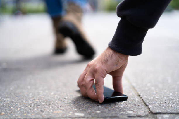 istock Person Picking Up A Lost Wallet 1320666723