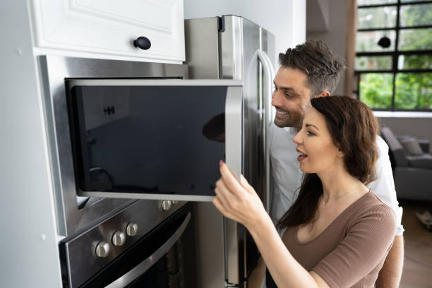 istock Couple Buying Microwave Oven With Consumer Loan 1320667549